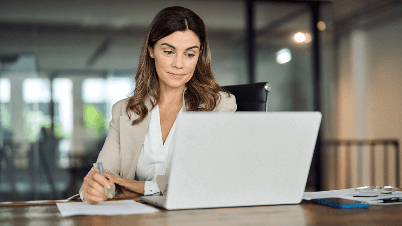 Woman sitting in front of a laptop at the office