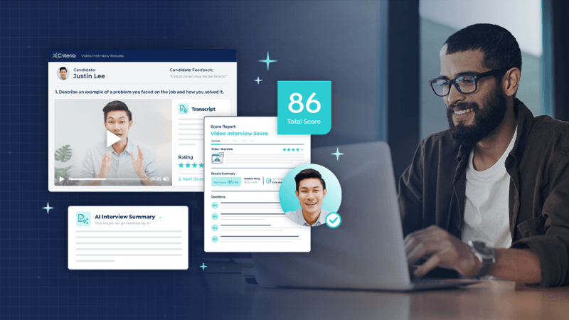 A smiling man sits in front of his laptop at work and on the left of the image, the new features of Interview Intelligence are highlighted, including automated interview scoring