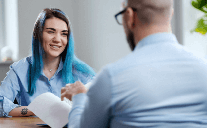 Job candidate with blue dyed hair being interviewed for a new job