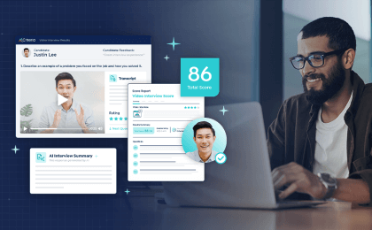 A smiling man sits in front of his laptop at work and on the left of the image, the new features of Interview Intelligence are highlighted, including automated interview scoring