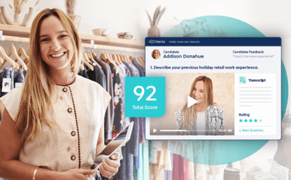 Female manager standing in front of clothing rack at retail store with a screenshot of Criteria's IIQ product showing a high candidate match.