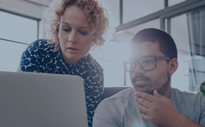 woman and man looking at computer