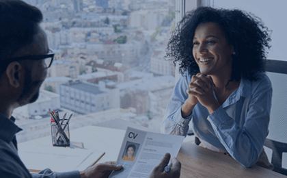 Woman smiling in a meeting with manager