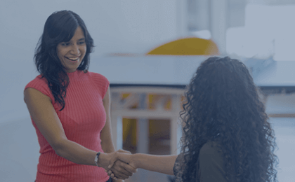 Two women shaking hands