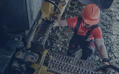 man climbing into large machine