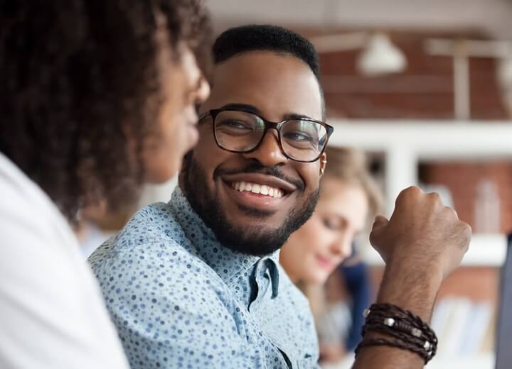 man smiling at woman